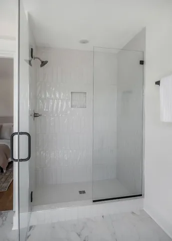 a bathroom with a granite countertop shower