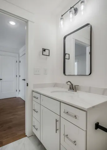 a bathroom with a double vanity sink and a mirror