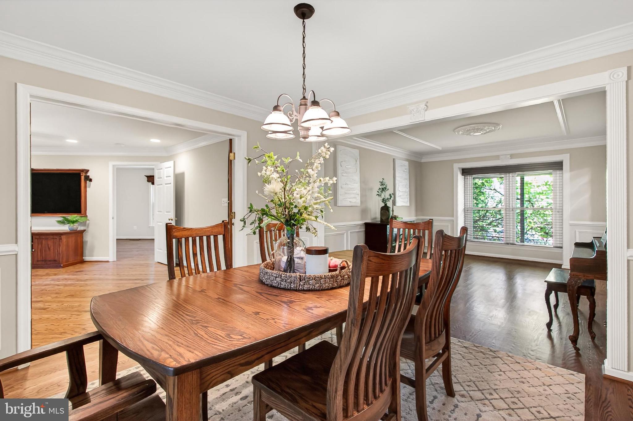 15117 Philip Lee Road Chantilly, VA 20151 - Photo 15 of 80 a dining room with furniture a chandelier and wooden floor
