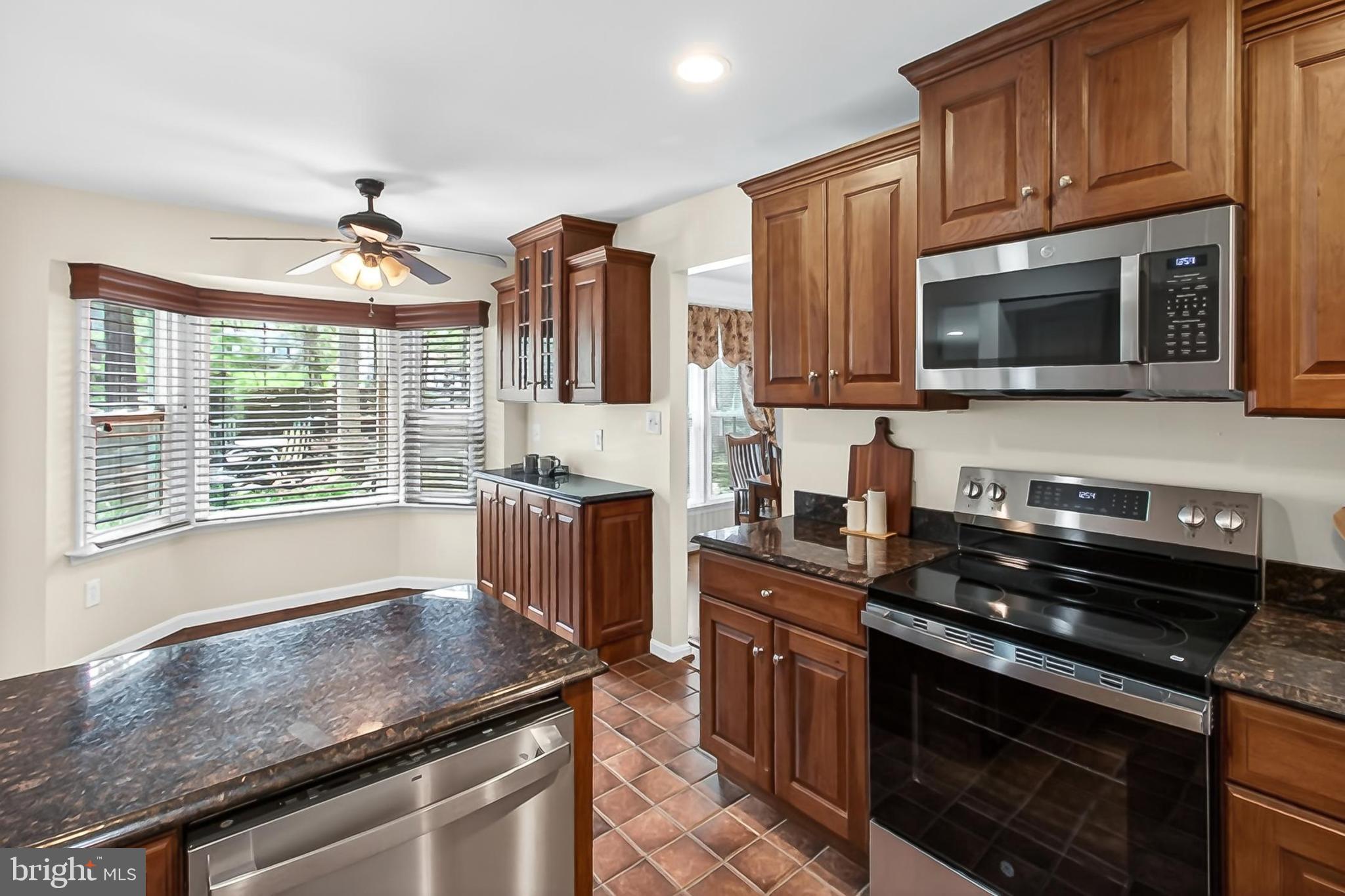 15117 Philip Lee Road Chantilly, VA 20151 - Photo 23 of 71 a kitchen with granite countertop a sink stainless steel appliances and cabinets