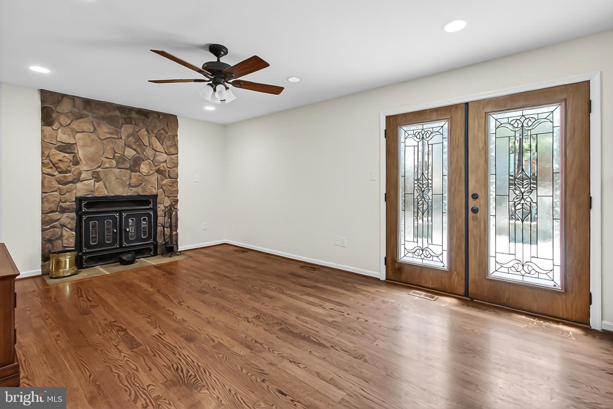 15117 Philip Lee Road Chantilly, VA 20151 - Photo 26 of 71 a view of an empty room with a fireplace and a window