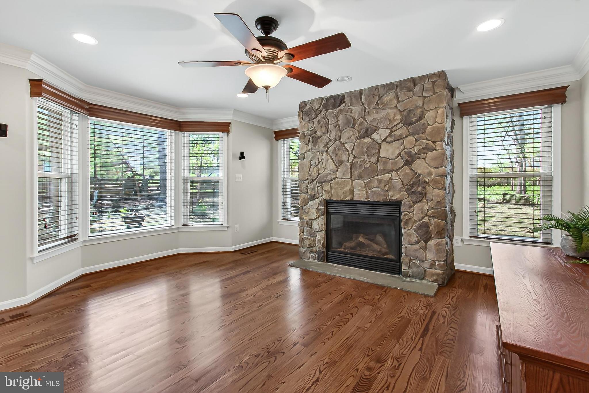 15117 Philip Lee Road Chantilly, VA 20151 - Photo 33 of 71 a view of an empty room with wooden floor fireplace and a window