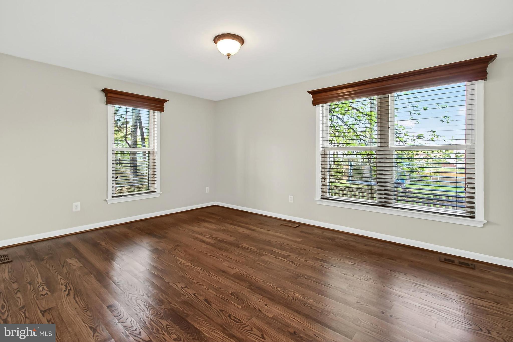 15117 Philip Lee Road Chantilly, VA 20151 - Photo 36 of 71 a view of an empty room with wooden floor and a window