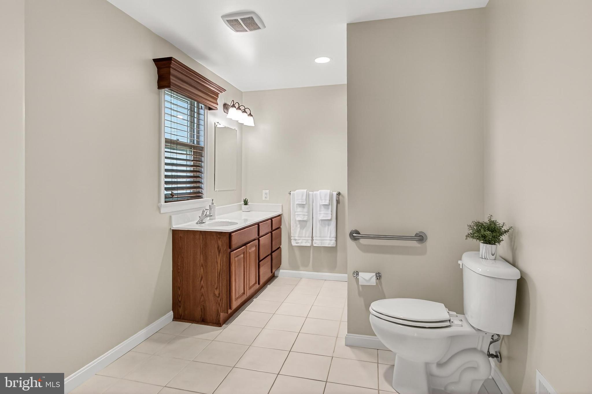 15117 Philip Lee Road Chantilly, VA 20151 - Photo 42 of 80 a bathroom with a toilet a sink and a mirror