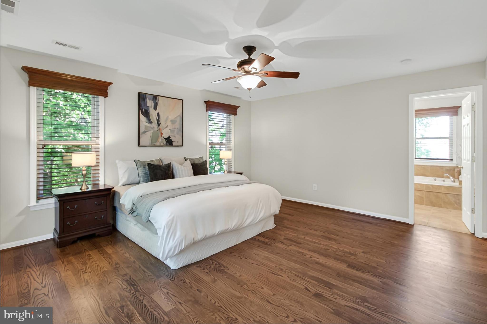 15117 Philip Lee Road Chantilly, VA 20151 - Photo 51 of 80 a bedroom with a large bed wooden floor and window
