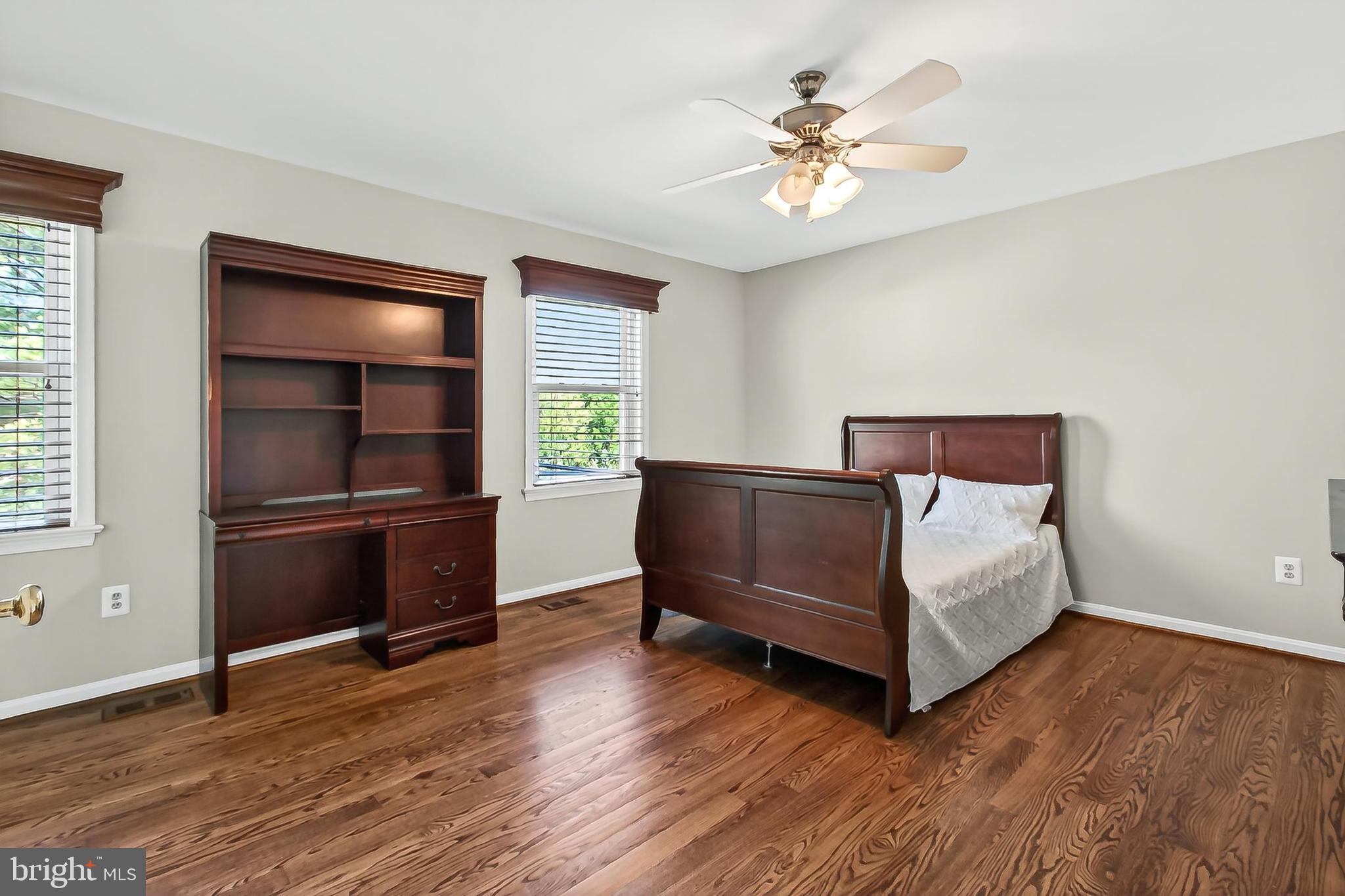 15117 Philip Lee Road Chantilly, VA 20151 - Photo 56 of 71 a bedroom with a bed and a ceiling fan