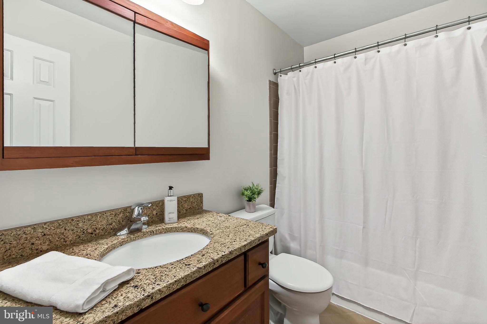 15117 Philip Lee Road Chantilly, VA 20151 - Photo 57 of 71 a bathroom with a granite countertop sink and a mirror with toilet