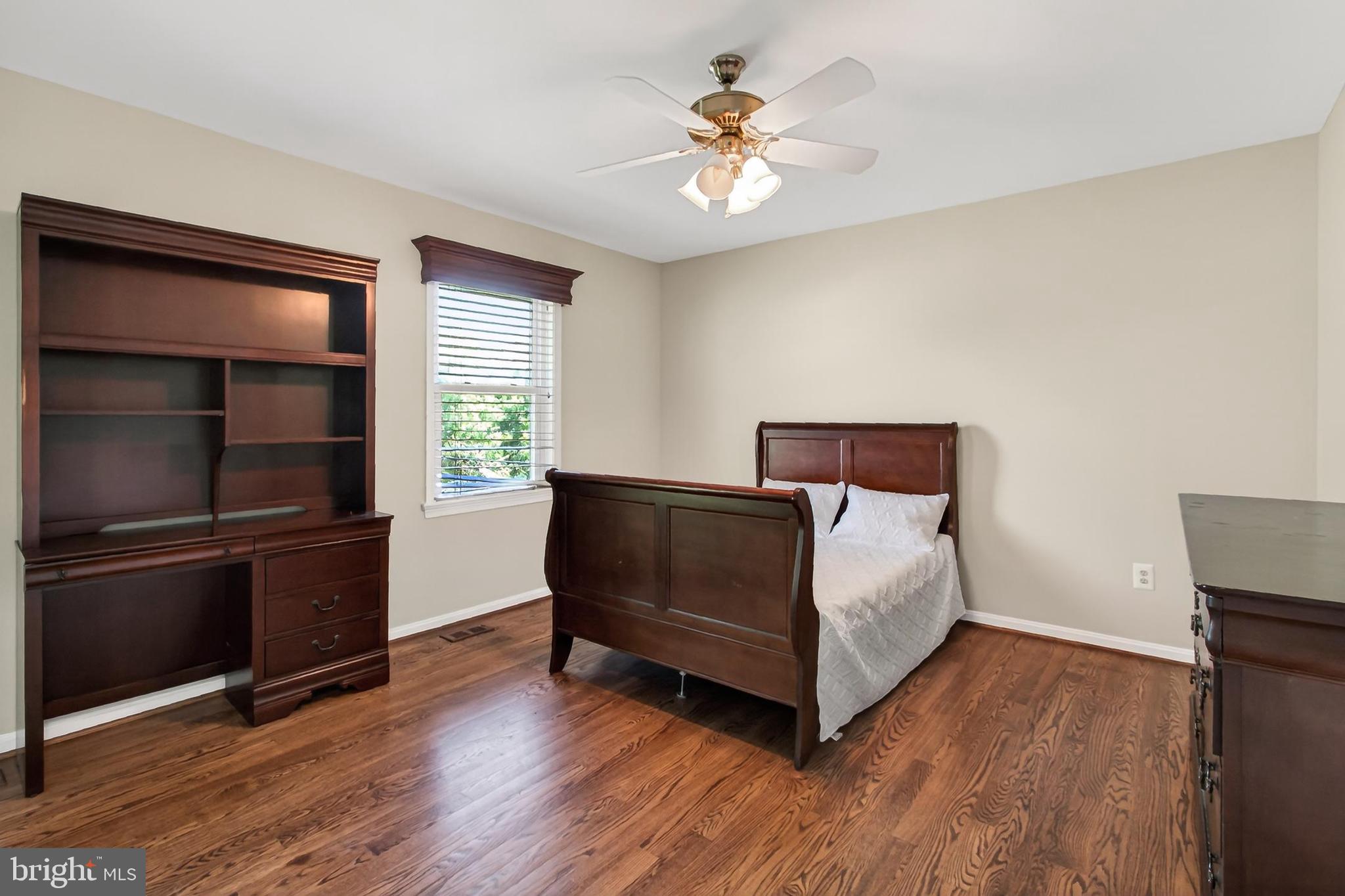 15117 Philip Lee Road Chantilly, VA 20151 - Photo 64 of 80 a bedroom with a bed and a chandelier