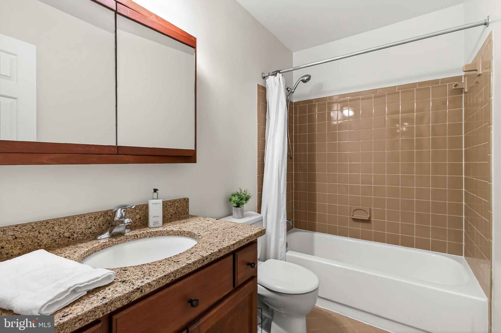 15117 Philip Lee Road Chantilly, VA 20151 - Photo 66 of 80 a bathroom with a granite countertop sink toilet and shower
