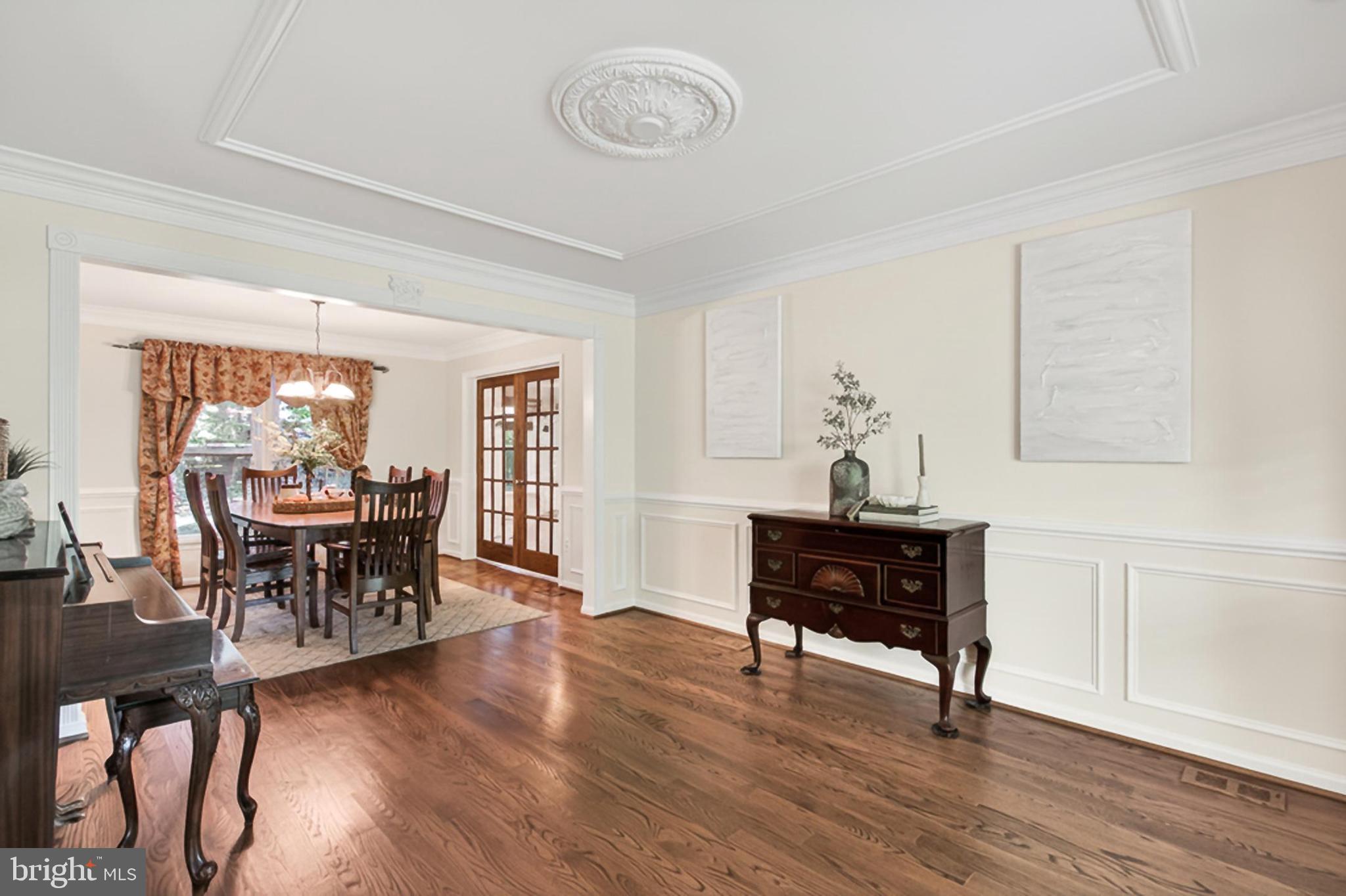15117 Philip Lee Road Chantilly, VA 20151 - Photo 9 of 80 a living room with furniture a dining table and a piano table with wooden floor