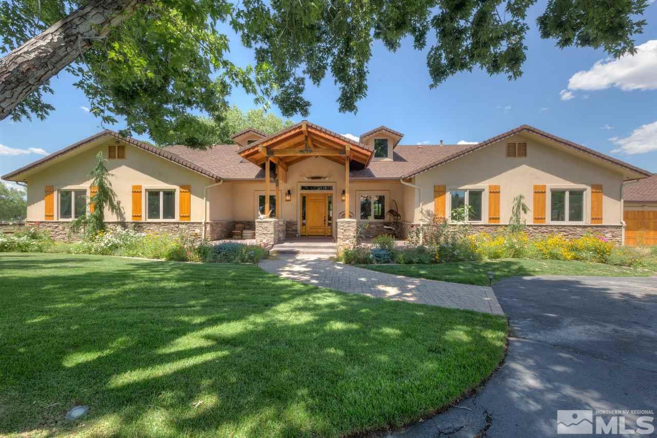 a front view of a house with a garden and yard