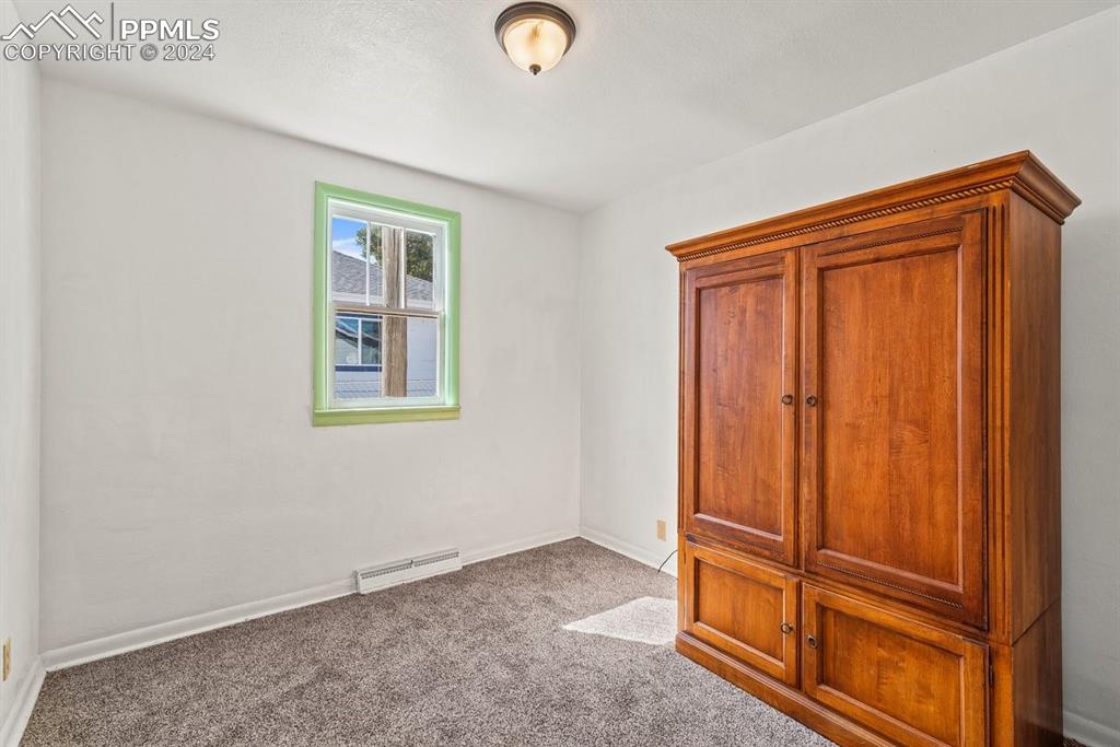 621 Edison Avenue La Junta, CO 81050 - Photo 17 of 30 an empty room with wooden floor and windows