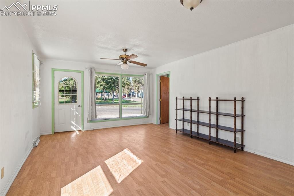 621 Edison Avenue La Junta, CO 81050 - Photo 9 of 30 a view of a room with windows and wooden floor
