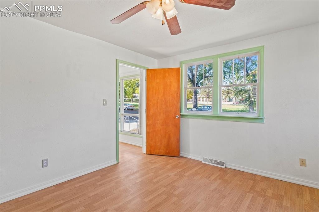 621 Edison Avenue La Junta, CO 81050 - Photo 10 of 30 a view of an empty room with a window and wooden floor