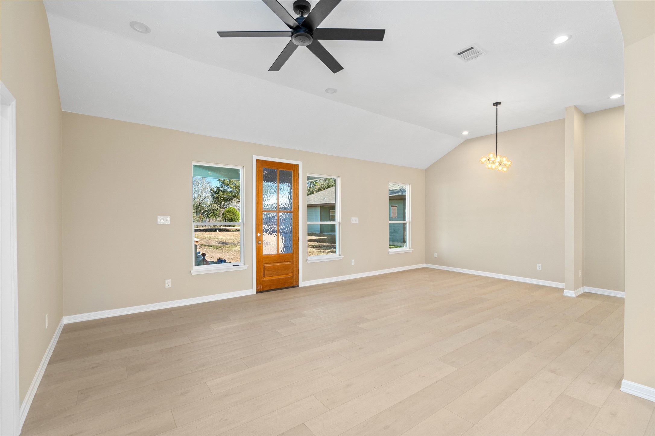 4654 North Teague Street Rosharon, TX 77583 - Photo 22 of 46 Step into a sun-filled living
area with vaulted ceilings,
sleek recessed lighting, and a
modern black ceiling fan.
Light hardwood floors and
neutral tones create an open,
inviting space perfect for
entertaining.
