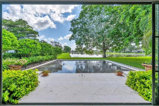 a view of a swimming pool with a yard
