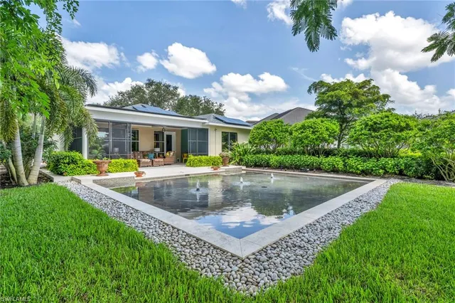 a view of a house with a swimming pool and a yard