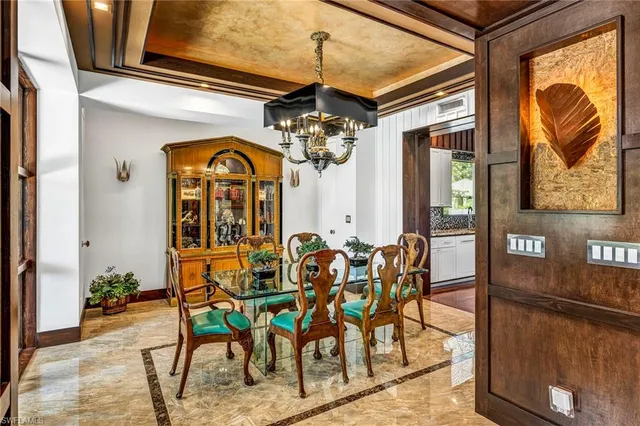 a view of a dining room with furniture and chandelier