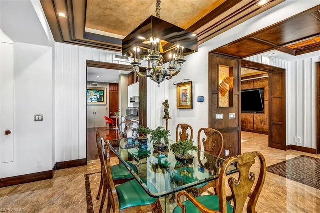 a view of a dining room with furniture and chandelier