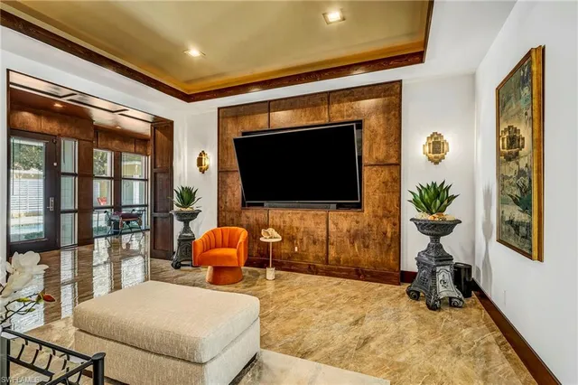 a living room filled with furniture and a flat screen tv