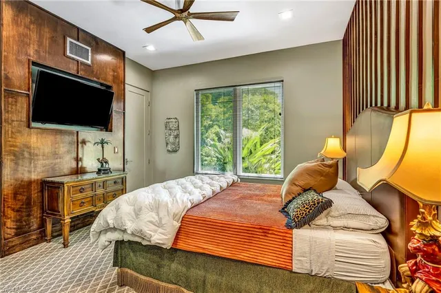 a bedroom with a bed and flat screen tv