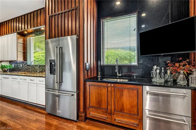 a kitchen with stainless steel appliances a refrigerator and a sink