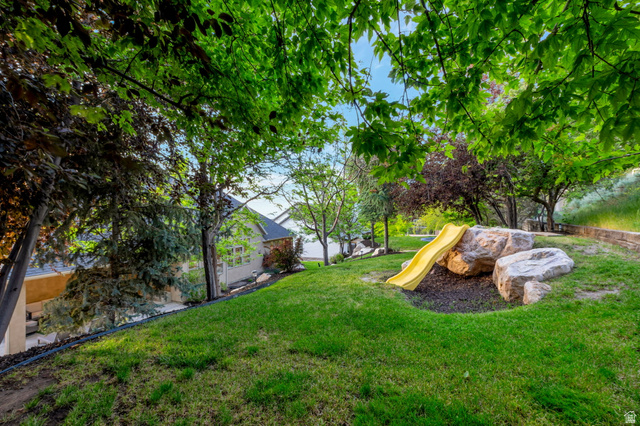 577 South Ridge Top Lane East North Salt Lake, UT 84054 - Photo 51 of 57 Large, shaded backyard with mature trees, established landscaping, and plenty of space to enjoy Utah's beautiful seasons.