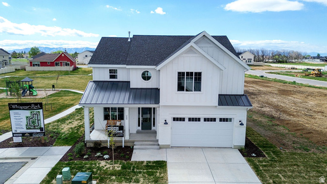 209 North 1140 West Mapleton, UT 84664 - Photo 21 of 21 Modern farmhouse featuring a standing seam roof, a garage, covered porch, a playground, and driveway