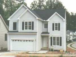 7800 Mill Run Raleigh, NC 27612 - Photo 1 of 1 a front view of a house with a yard and garage