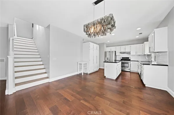 a view of kitchen with stainless steel appliances granite countertop a stove top oven