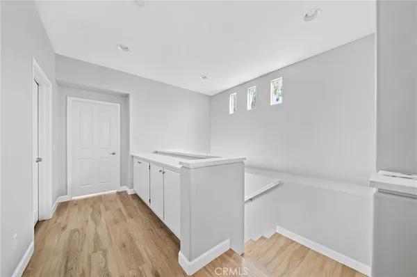 a view of hallway with wooden floor