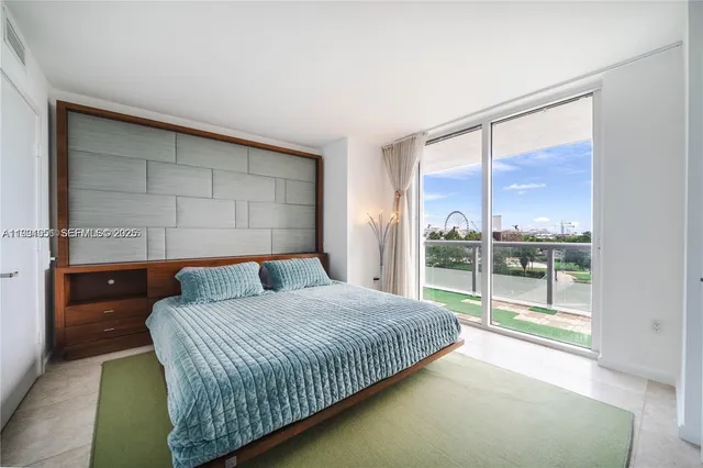 a bedroom with a large bed and a large window