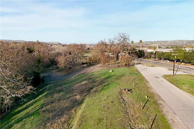an aerial view of a house with a yard and lake view