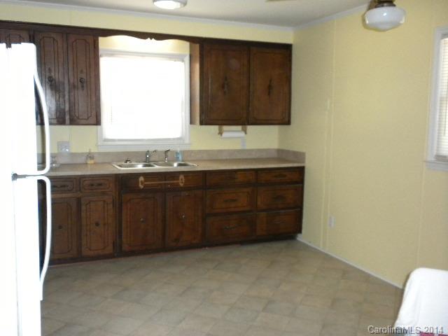 6918 Medlin Road Monroe, NC 28112 - Photo 4 of 11 a kitchen with a sink and a window