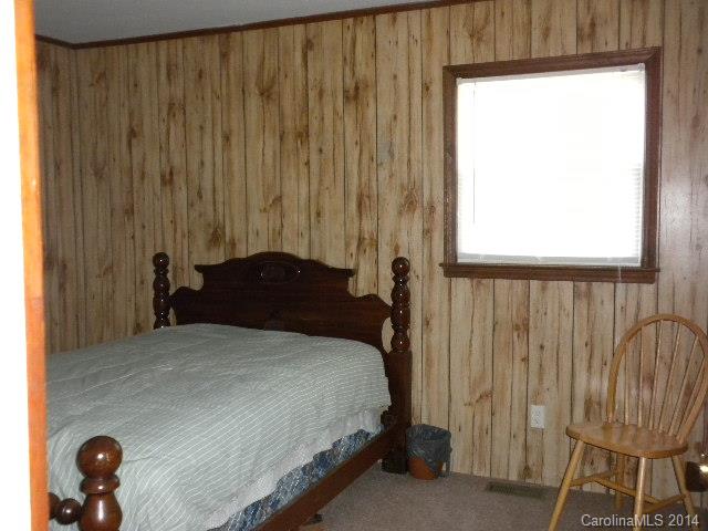 6918 Medlin Road Monroe, NC 28112 - Photo 7 of 11 a bedroom with a bed and a window