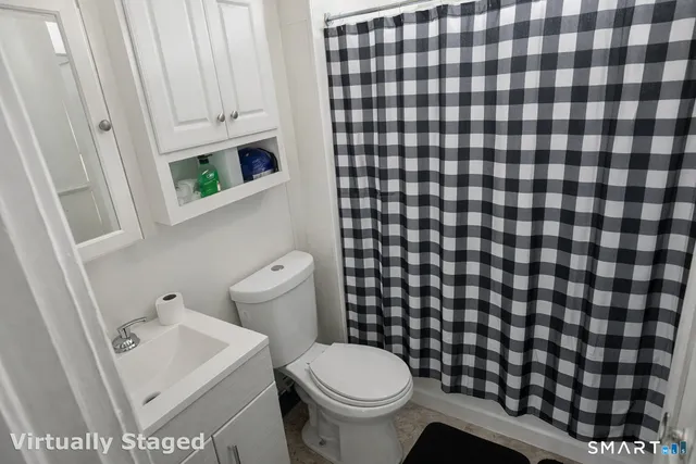 a bathroom with a toilet and a shower