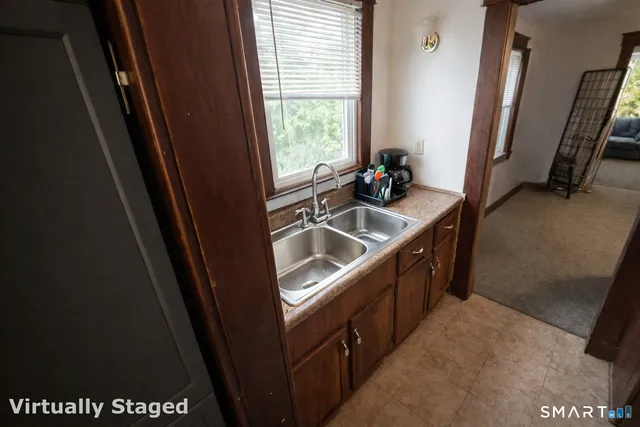 a kitchen with a sink a refrigerator and window