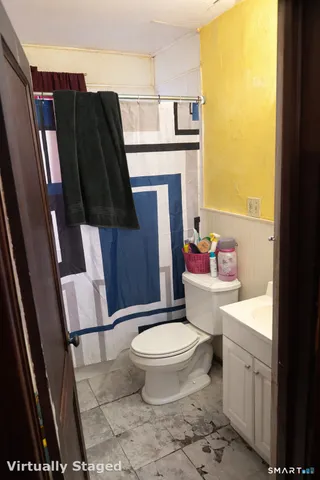 a bedroom with furniture and a large window