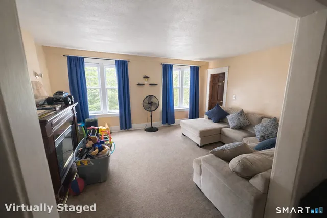 a view of a workspace with furniture and a window
