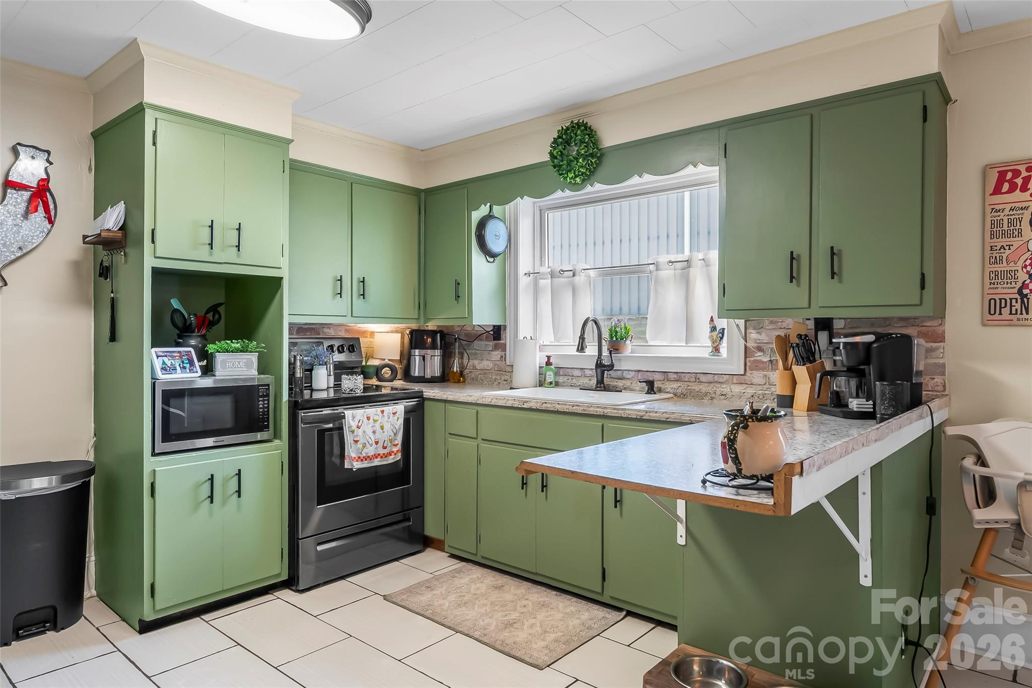691 Central Street Hudson, NC 28638 - Photo 7 of 22 a kitchen with cabinets a sink and a stove top oven