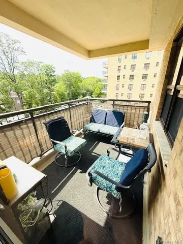 a living room with patio furniture and a floor to ceiling window