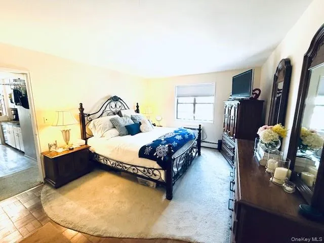 a bedroom with bed and a flat screen tv