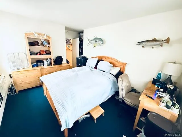 a bedroom with a bed and a book shelf