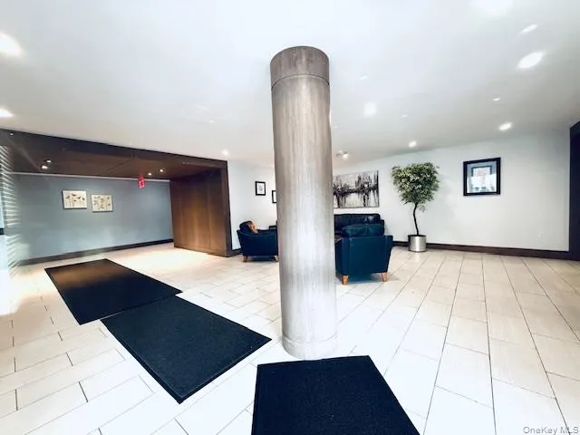 a living room with furniture and a mirror