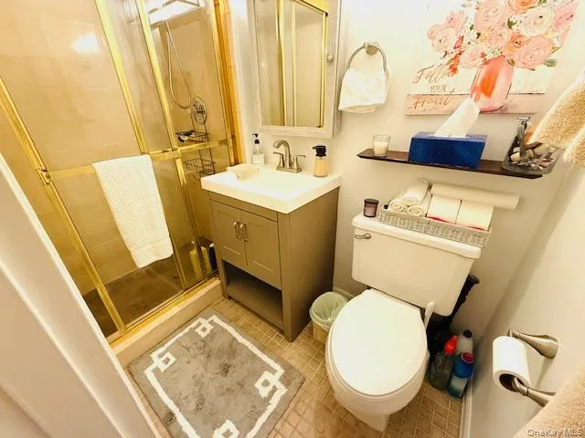 a bathroom with a sink mirror vanity and toilet