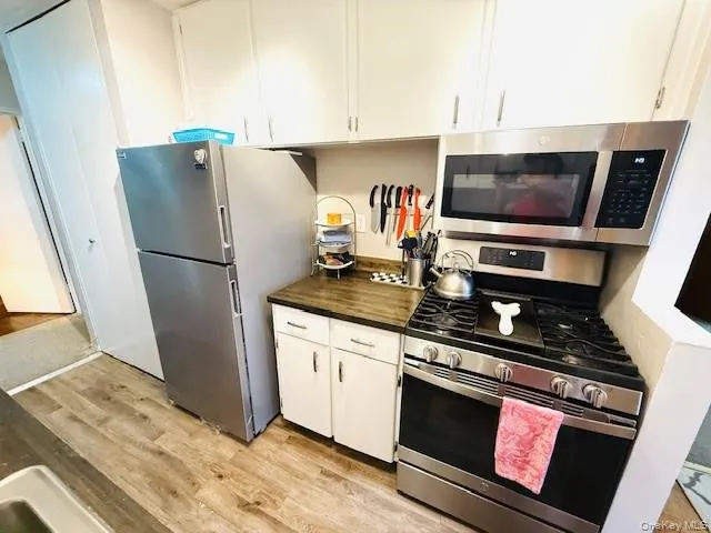 a kitchen with a refrigerator stove and microwave