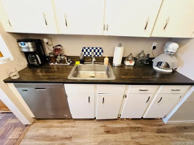a kitchen with a sink a stove and cabinets