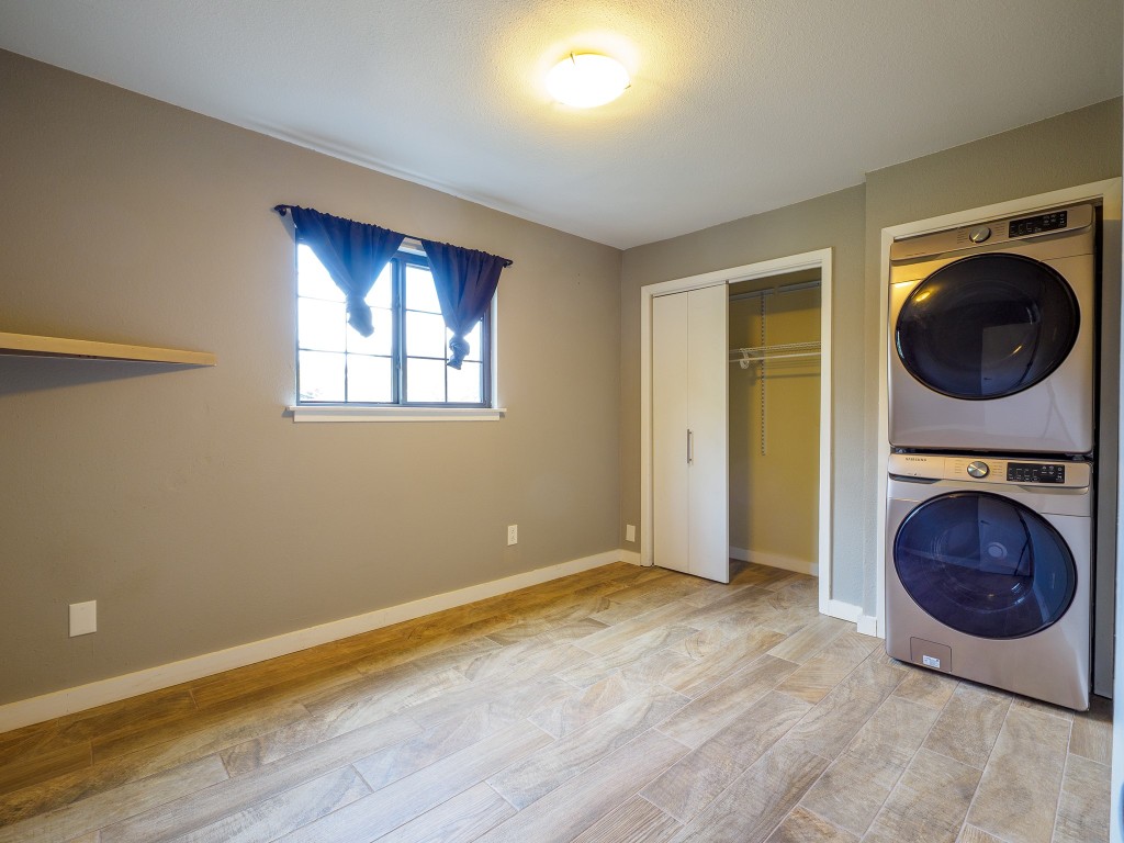 2302 East Side Drive, Unit 28 Austin, TX 78704 - Photo 12 of 16 a view of a bedroom with washer and dryer