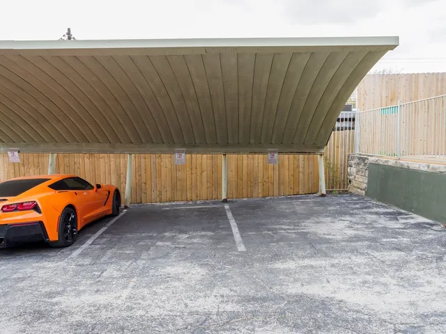 a view of a backyard with parking space