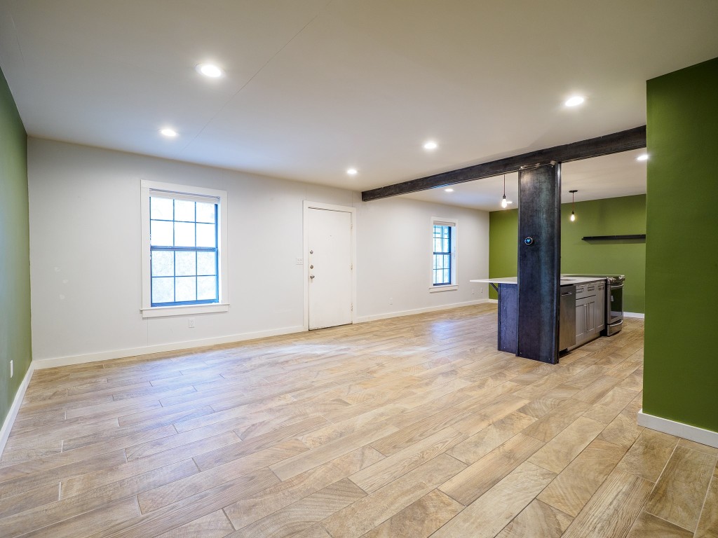 2302 East Side Drive, Unit 28 Austin, TX 78704 - Photo 9 of 16 a view of an empty room with glass door and balcony